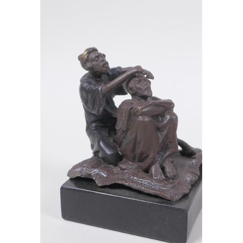 32 - A Bergman style bronze figure of an Arab barber, 8cm high