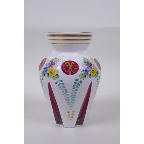 35 - A Bohemian style overlaid ruby glass vase with hand painted floral decoration, and a similar pot and... 