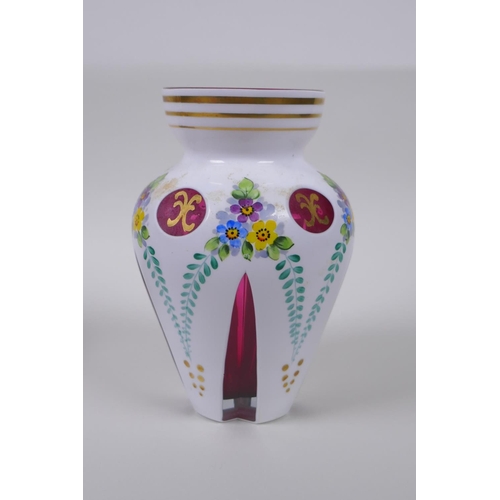 35 - A Bohemian style overlaid ruby glass vase with hand painted floral decoration, and a similar pot and... 