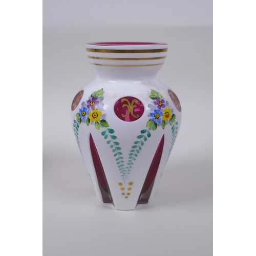 35 - A Bohemian style overlaid ruby glass vase with hand painted floral decoration, and a similar pot and... 