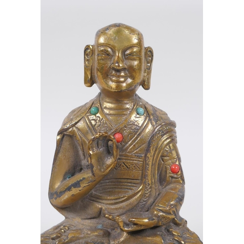 38 - A Sino Tibetan gilt bronze figure of Buddha seated in meditation inset with semi precious stones, im... 