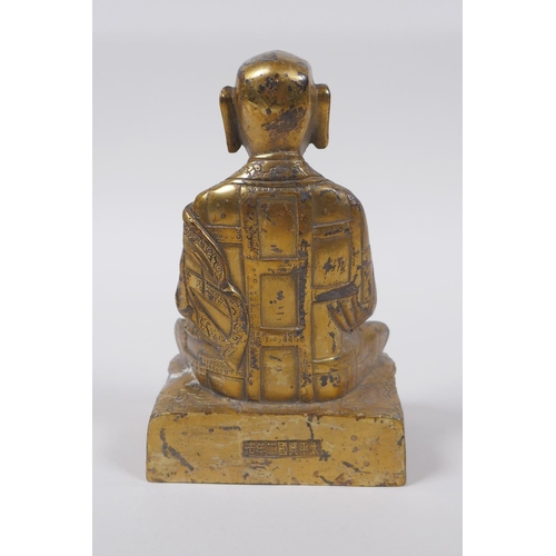 38 - A Sino Tibetan gilt bronze figure of Buddha seated in meditation inset with semi precious stones, im... 