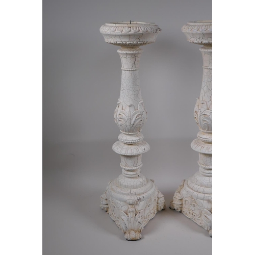 39 - A pair of painted composition pricket candlesticks, 54cm high