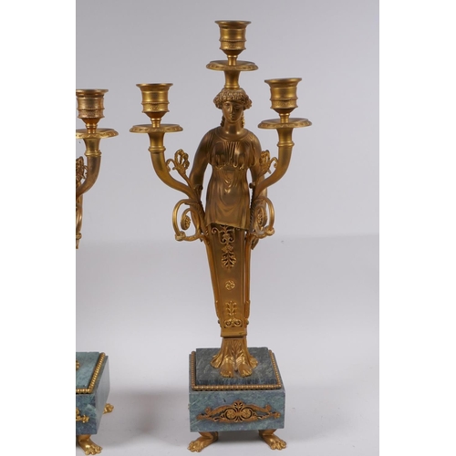 47 - A pair of Ormolu three branch candelabra in the form of Greco Roman women, raised on vert de mer bas... 