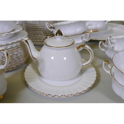 49 - A Royal Albert Val d'Or dinner and tea service of white and gilt design, comprising eighteen 26cm di... 