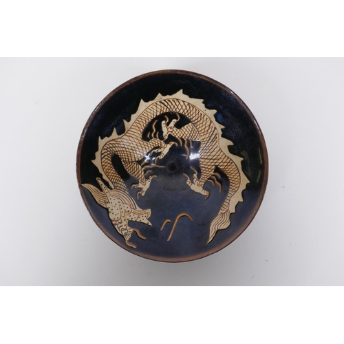 55 - A Chinese Cizhou kiln conical bowl with dragon decoration, 15cm diameter