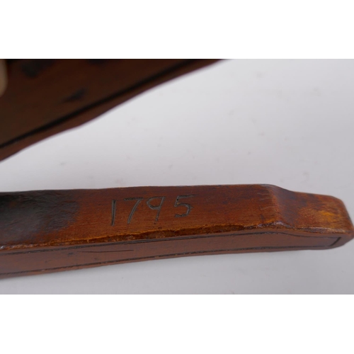 57 - An antique walnut nut cracker with copper plates, inscribed, 19cm long