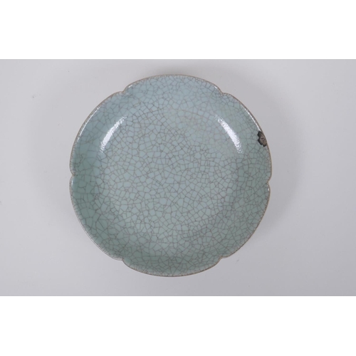 58 - A Chinese celadon glazed porcelain dish with a petal shaped rim, AF, 19cm diameter