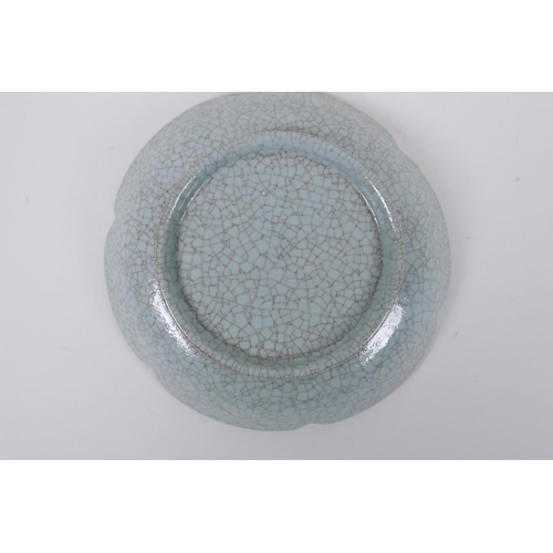 58 - A Chinese celadon glazed porcelain dish with a petal shaped rim, AF, 19cm diameter