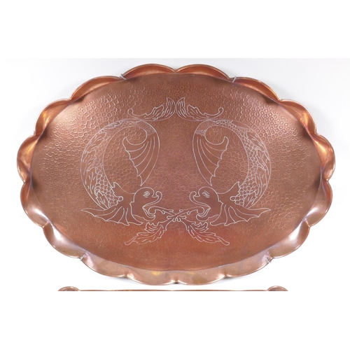 6 - A Newlyn style hand made copper tray with dolphin decoration and another similar with Art Nouveau de... 