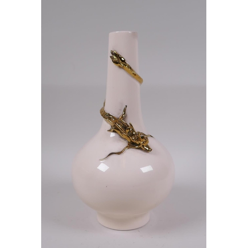 61 - A Chinese peach ground porcelain vase with applied and gilt dragon decoration, 25cm high, seal mark ... 