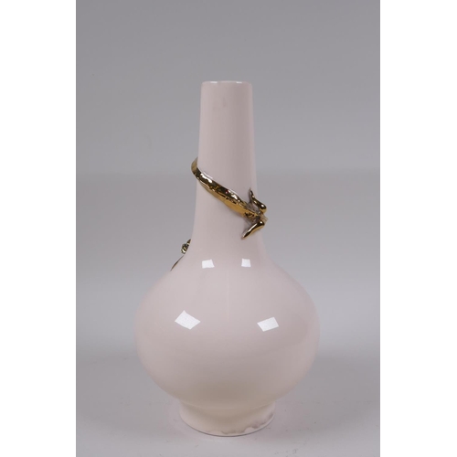 61 - A Chinese peach ground porcelain vase with applied and gilt dragon decoration, 25cm high, seal mark ... 