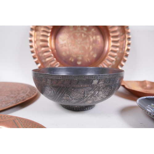 62 - A large quantity of oriental metal wares including a bidri ware bowl, copper dishes, brass dishes an... 