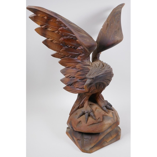 77 - A Black Forest carved wood figure of an eagle with outstretched wings, 52cm high