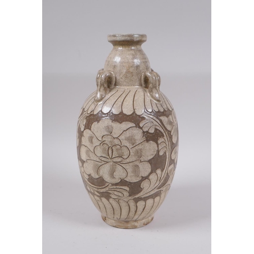 81 - A Chinese Cizhou kiln vase with four loop handles and chased floral decoration, 23cm high