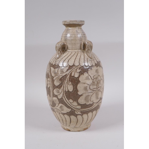 81 - A Chinese Cizhou kiln vase with four loop handles and chased floral decoration, 23cm high