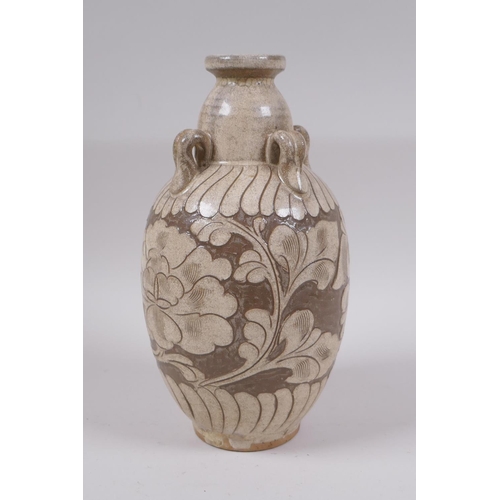 81 - A Chinese Cizhou kiln vase with four loop handles and chased floral decoration, 23cm high