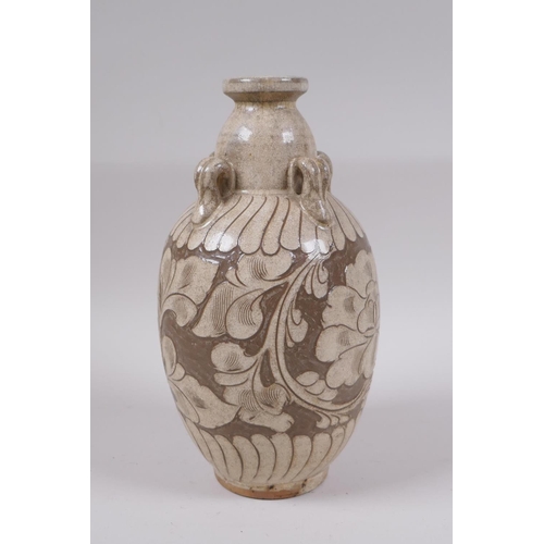 81 - A Chinese Cizhou kiln vase with four loop handles and chased floral decoration, 23cm high