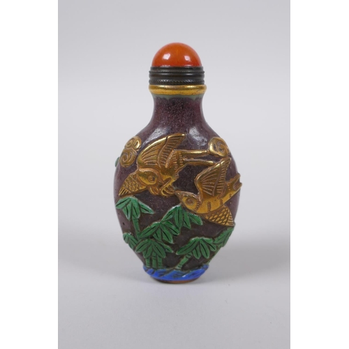 83 - A Peking glass snuff bottle with carved, enamelled and gilt bird decoration, 8cm high