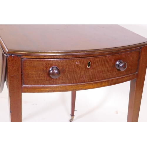 1104 - A George III mahogany Pembroke table with single drawer and bow ends, raised on square tapering supp... 