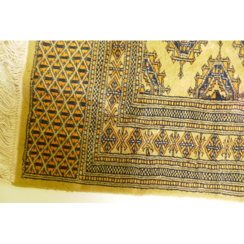 1106 - A gold ground Bokhara rug, 120 x 190cm