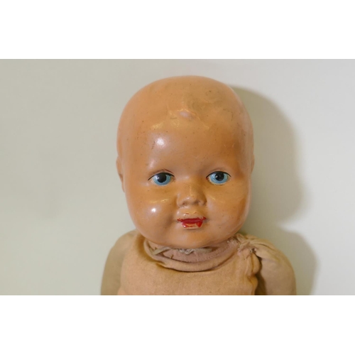 249 - An antique composition head doll with rolling eyes, marked RII and another with painted face marked ... 