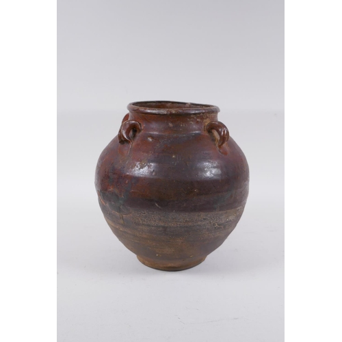 232 - A antique glazed terracotta jar with four lug handles, 20cm high