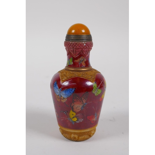 236 - A Chinese moulded glass snuff bottle with enamelled butterfly decoration, 4 character mark to base, ... 