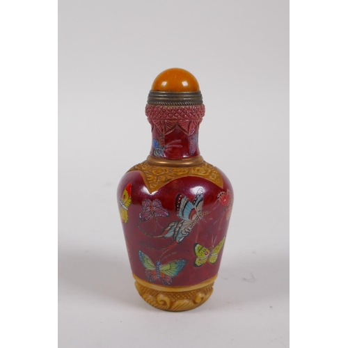 236 - A Chinese moulded glass snuff bottle with enamelled butterfly decoration, 4 character mark to base, ... 