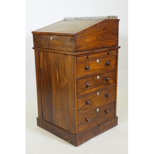 1022 - A Victorian rosewood davenport desk, with three quarter gallery and covered inkwell compartment, sli... 