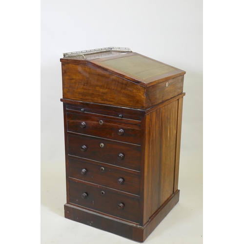 1022 - A Victorian rosewood davenport desk, with three quarter gallery and covered inkwell compartment, sli... 