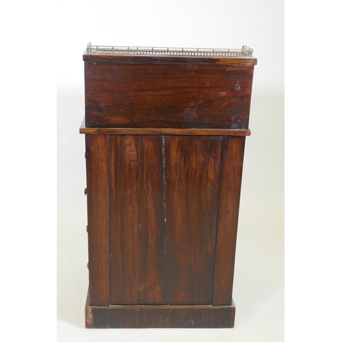 1022 - A Victorian rosewood davenport desk, with three quarter gallery and covered inkwell compartment, sli... 