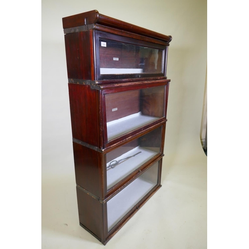 1025 - A mahogany Globe Wernicke bookcase of four sections, the upper stepped, lacks base, 87 x 29 x 48cm