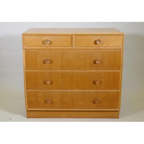 1026 - A mid century Meredew oak veneered chest of two over three drawers, raised on a plinth base, AF some... 