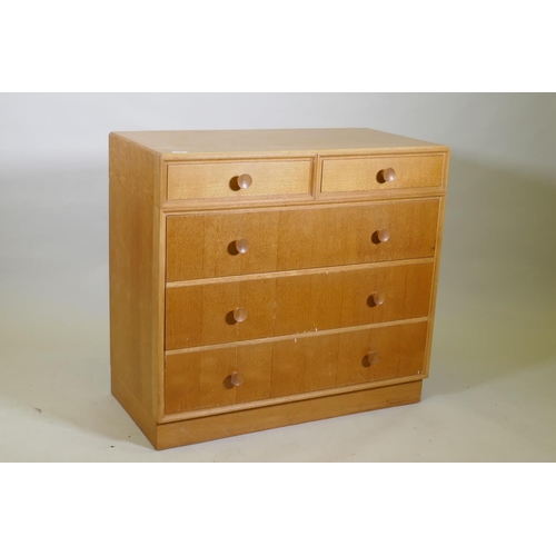 1026 - A mid century Meredew oak veneered chest of two over three drawers, raised on a plinth base, AF some... 