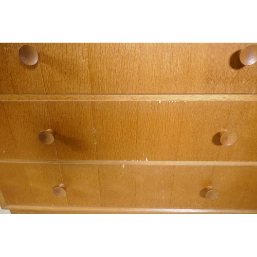 1026 - A mid century Meredew oak veneered chest of two over three drawers, raised on a plinth base, AF some... 