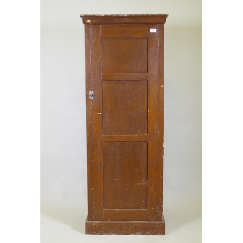 1027 - A late C19th/early C20th grain painted cupboard with panelled sides and door, rope twist carved top ... 