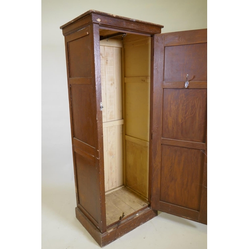 1027 - A late C19th/early C20th grain painted cupboard with panelled sides and door, rope twist carved top ... 