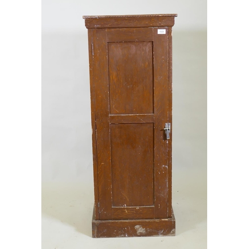 1028 - A late C19th/early C20th grain painted cupboard with panelled sides and door, rope twist carved top ... 