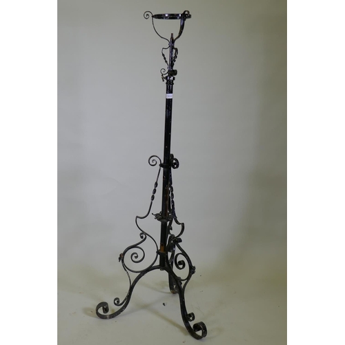 1030 - A Victorian wrought iron telescopic floor lamp stand, 150cm high, 186cm extended