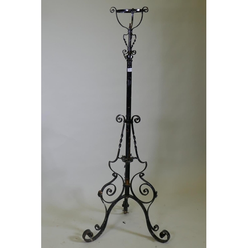 1030 - A Victorian wrought iron telescopic floor lamp stand, 150cm high, 186cm extended