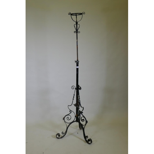 1030 - A Victorian wrought iron telescopic floor lamp stand, 150cm high, 186cm extended