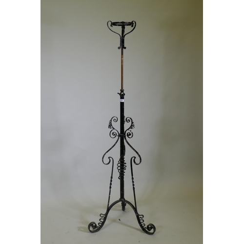 1031 - A Victorian wrought iron telescopic floor lamp stand, 138cm high, 200cm extended