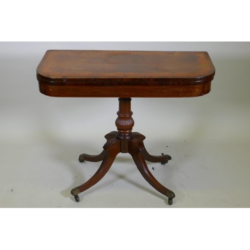 1034 - A Regency rosewood card table with satinwood inlaid borders, fold over top and inlaid frieze, raised... 