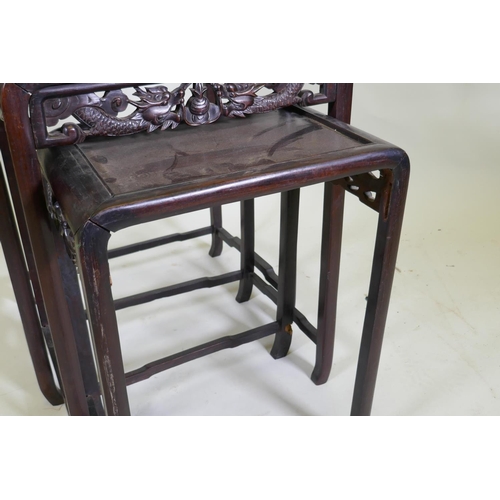 1036 - A nest of Chinese hardwood tables with carved dragon decoration, AF losses, largest 50 x 36, 72cm hi... 