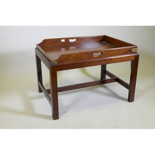 1037 - An antique mahogany butler's tray with brass mounts and shaped end gallery, raised on a later base, ... 