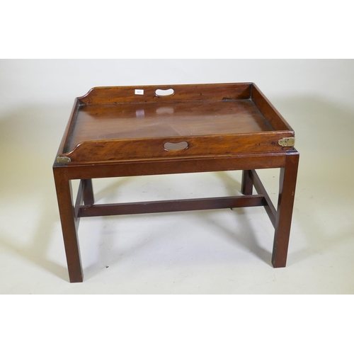 1037 - An antique mahogany butler's tray with brass mounts and shaped end gallery, raised on a later base, ... 