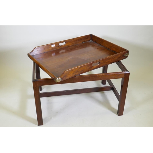 1037 - An antique mahogany butler's tray with brass mounts and shaped end gallery, raised on a later base, ... 