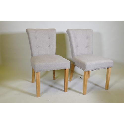 1041 - A pair of contemporary button back side chairs, raised on square tapering beechwood supports