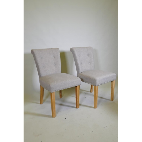 1041 - A pair of contemporary button back side chairs, raised on square tapering beechwood supports